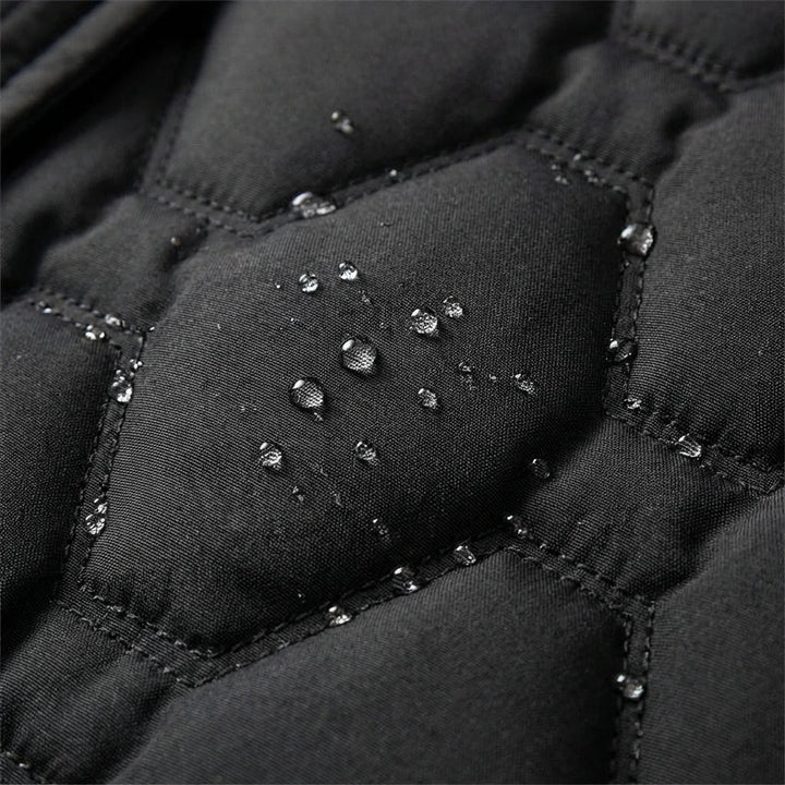 Jacqueline longline hooded quilted coat by Bennett & Lowe, shown in dark grey with a front zipper and oversized fit.
