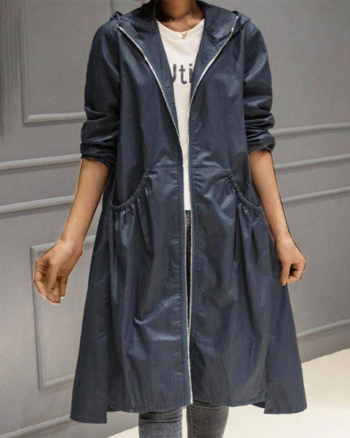 Women’s Kathleen Bennett and Lowe waterproof hooded long trench coat with zip-up front, stylish and functional outerwear for rainy days.