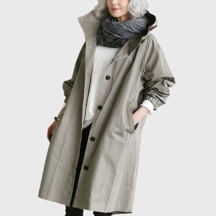 Women’s waterproof hooded relaxed-fit long trench coat by Bennett and Lowe, shown in a stylish water-resistant design.