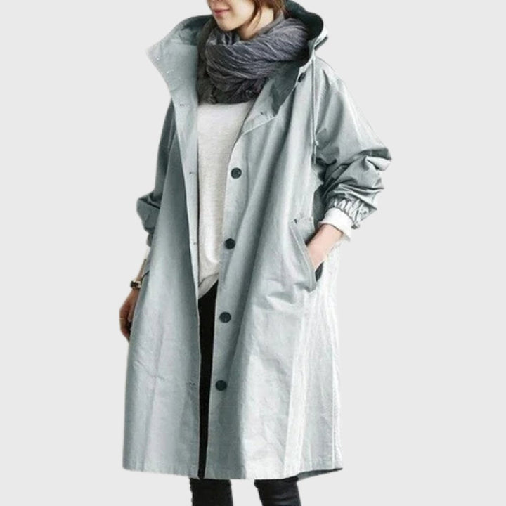 Women's waterproof hooded long trench coat by Bennett and Lowe, relaxed-fit design, shown in dark color with a belt and pockets.