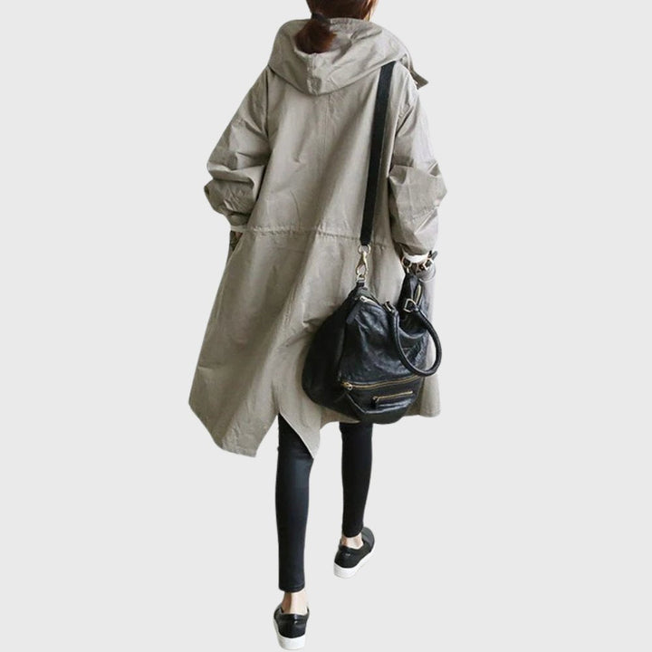 Women’s waterproof hooded long trench coat by Bennett and Lowe, relaxed fit, stylish and functional for rainy weather.