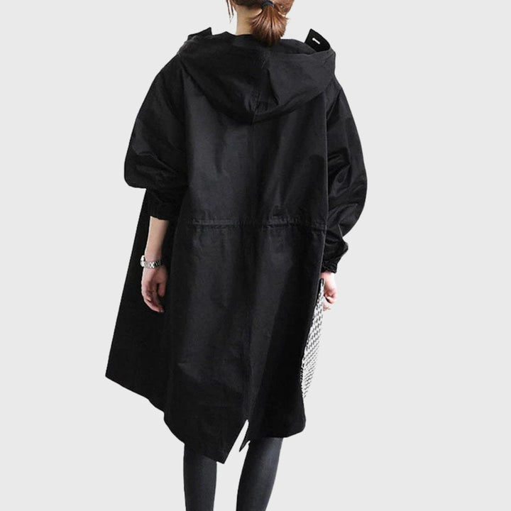 Women’s hooded waterproof relaxed-fit long trench coat by Bennett and Lowe, shown in a neutral color with a hood and belted waist.
