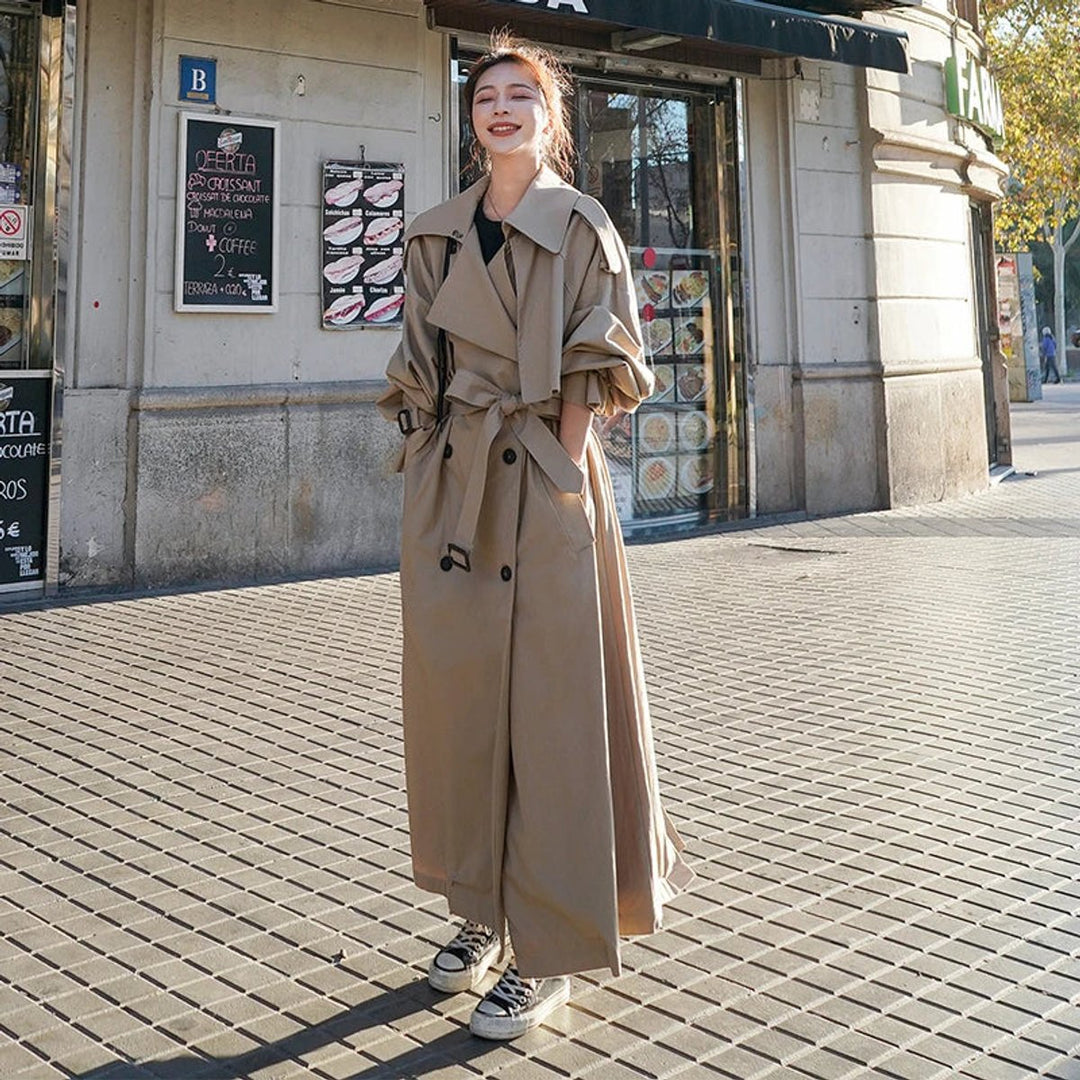Lena oversized double-breasted long trench coat for women by Bennett and Lowe, beige fabric with wide lapels and belt detail.