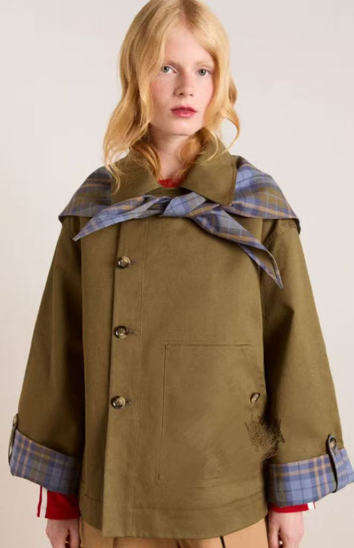 Women’s oversized Bennett and Lowe utility coat with double-breasted design, plaid lining, and trench coat style.