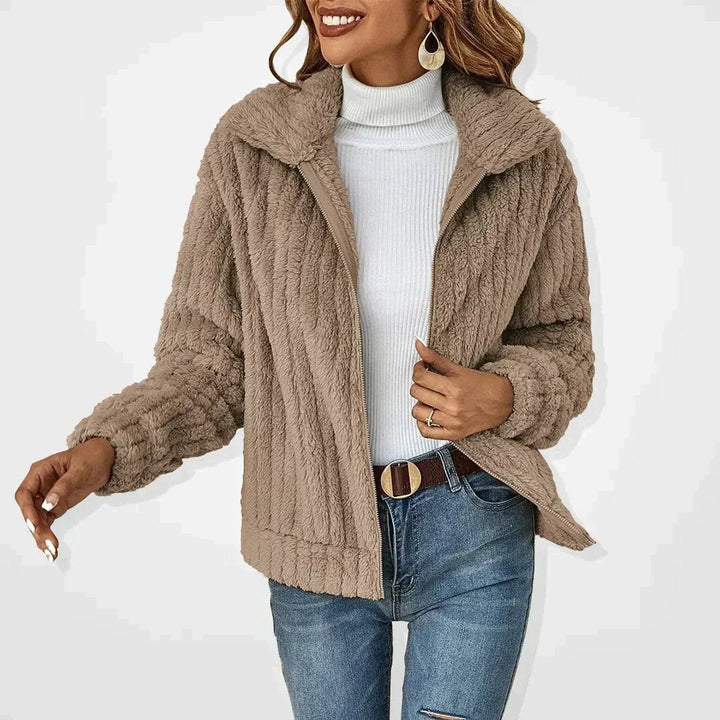 Women’s quilted zip-up jacket by Bennett and Lowe featuring plush fleece lining and cozy, fluffy exterior for warmth and comfort.